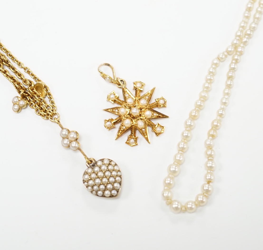 An Edwardian 15ct gold and seed pearl set starburst pendant, overall 25mm, together with a similar yellow metal and seed pearl set heart shaped drop pendant necklace, approx. 38cm (twisted) and a seed pearl necklace with